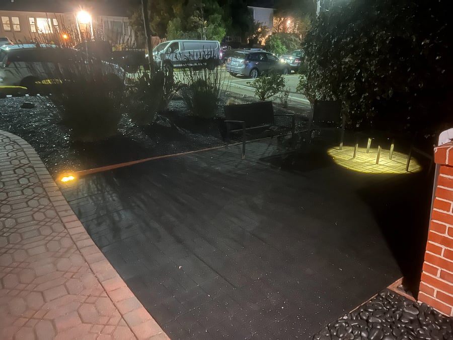 view of open air front yard seating at night. 