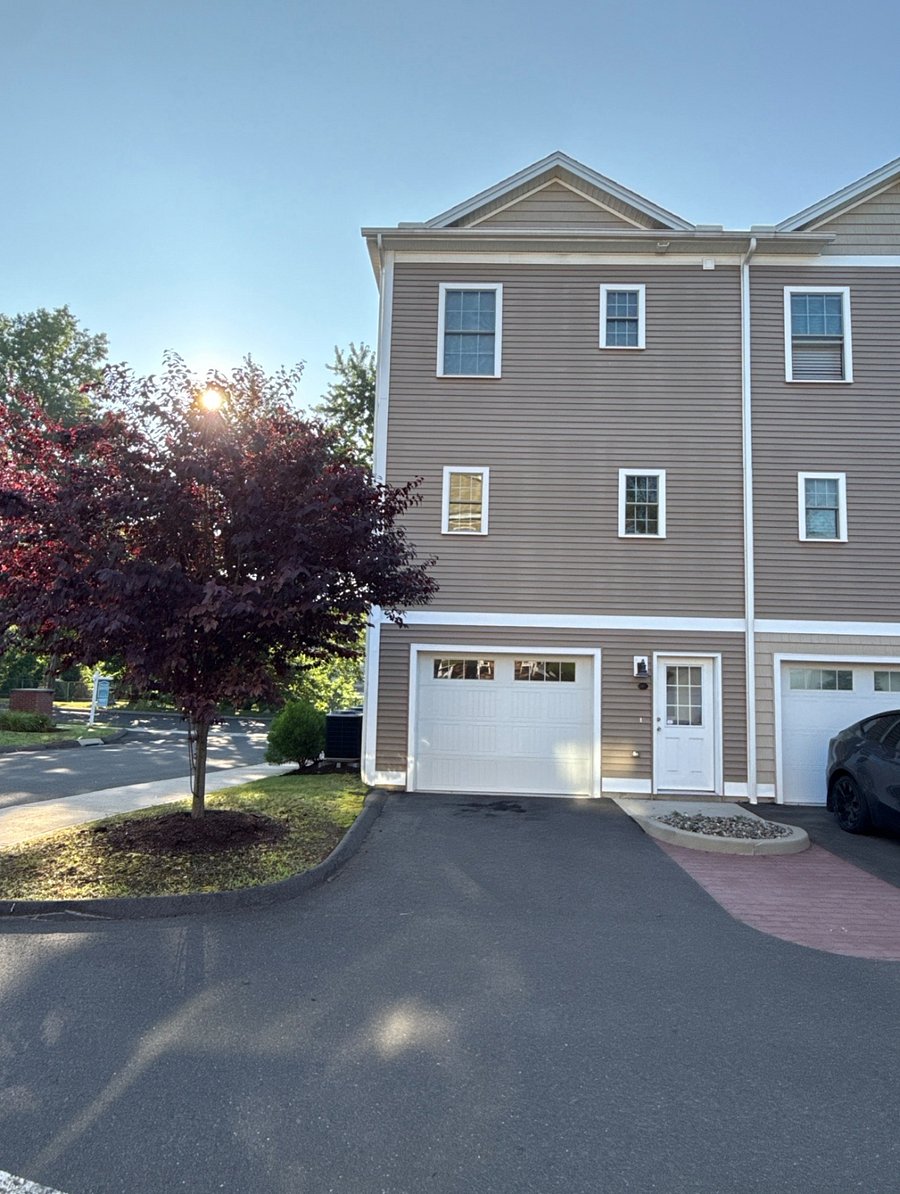 Two Dedicated Parking Spots: Covered parking in garage and outdoor spot in front of garage entrance in private lot.