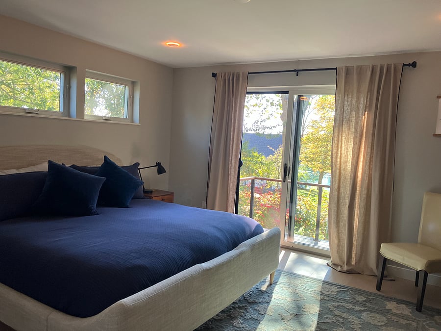 Primary bedroom, king bed, large walk-in closet and balcony with river views