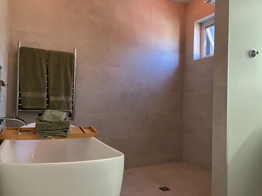 Primary bathroom with soaking tub and rain shower