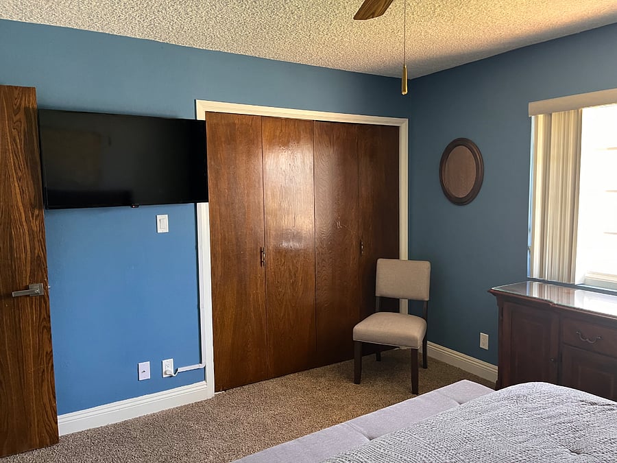 Corner bedroom, large room at the end of the hallway and next to the bathroom.