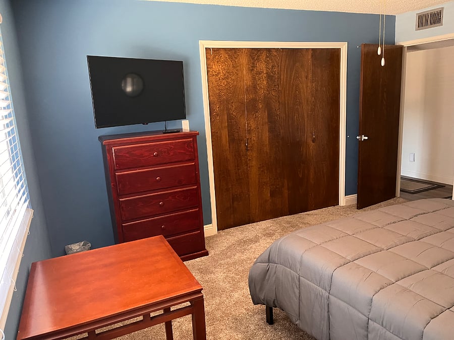 Middle bedroom, large and comfortable with queen bed plus a table and two chairs