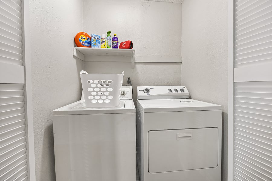 Laundry room with laundry supplies and basket.