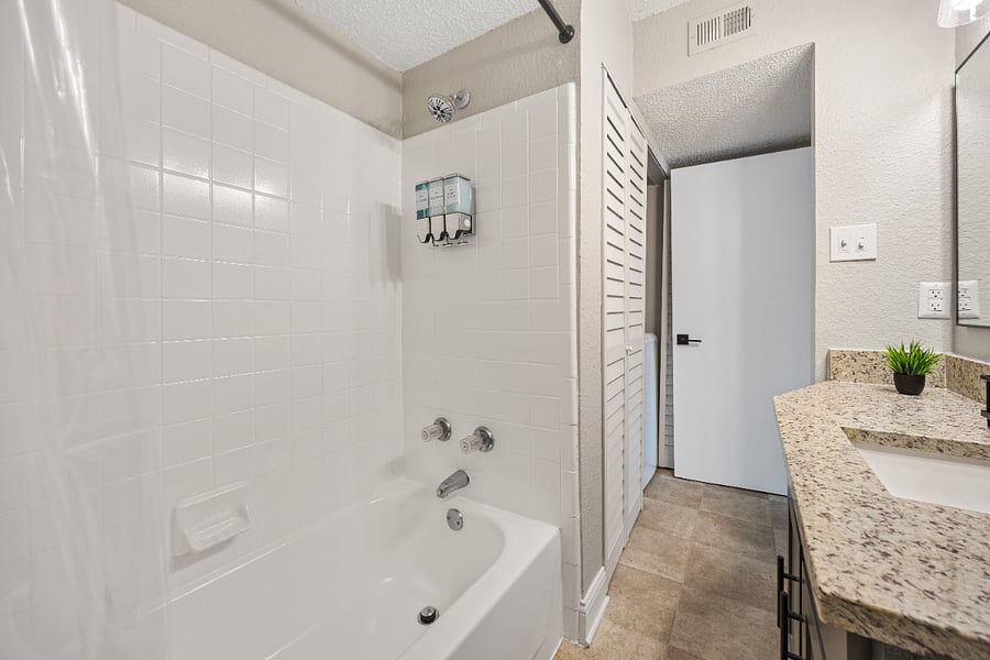 Full bathroom with toilet, tub, shower, hair dryer, bathroom essentials, etc.