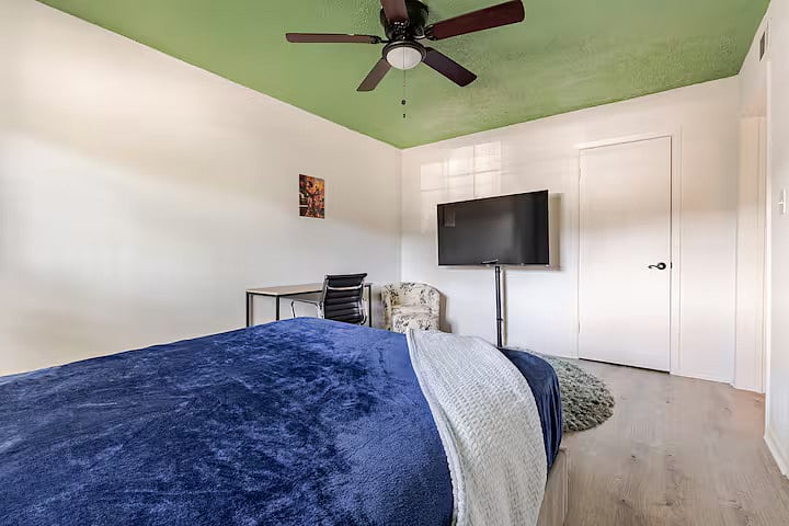 Master Bedroom with workspace and smart TV.