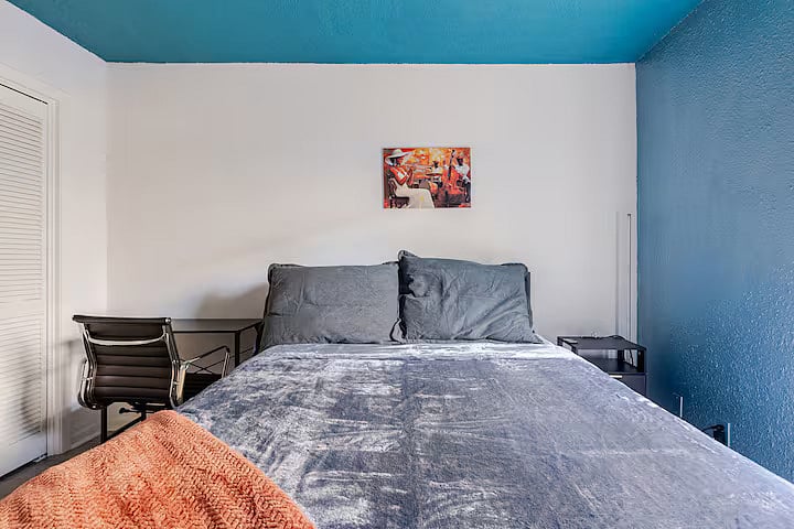 2nd Bedroom with a queen bed, a desk, and a smart tv.