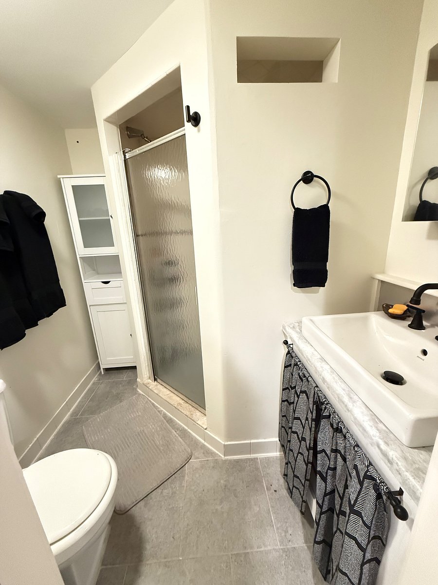 Private full bathroom with linens and oversized shower.