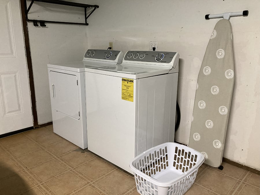Laundry facilities located inside garage. Includes ironing board and iron.