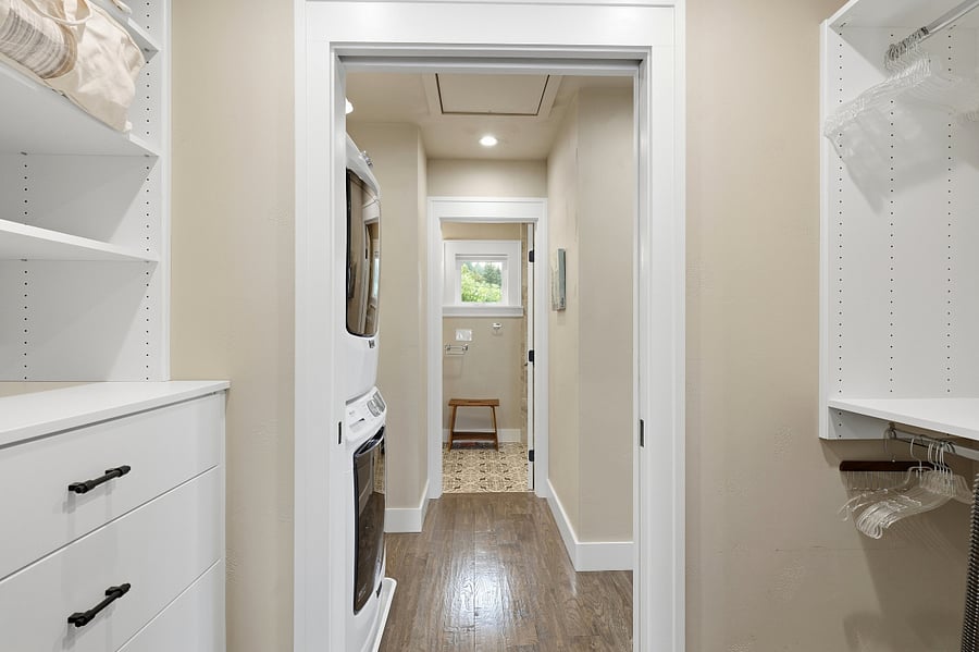 Hallway through closet from bedroom #2 to bathroom #2 with laundry