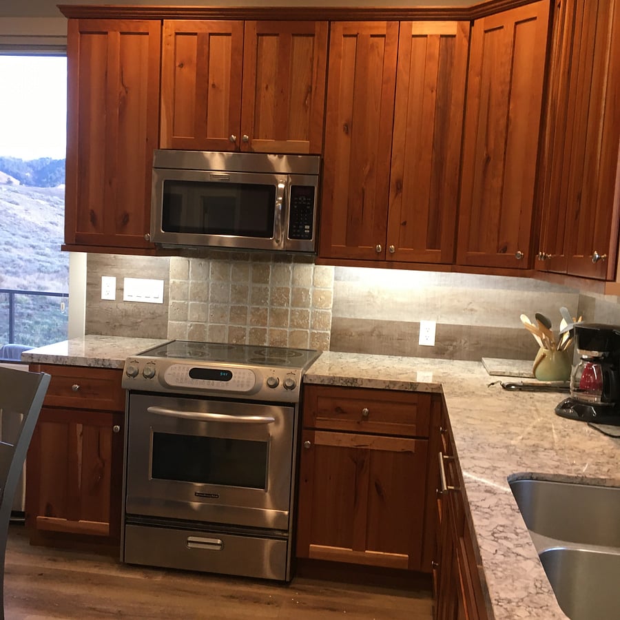 One side of the well equipped kitchen with custom cherry cabinets. Tons of storage in the numerous cabinets. 