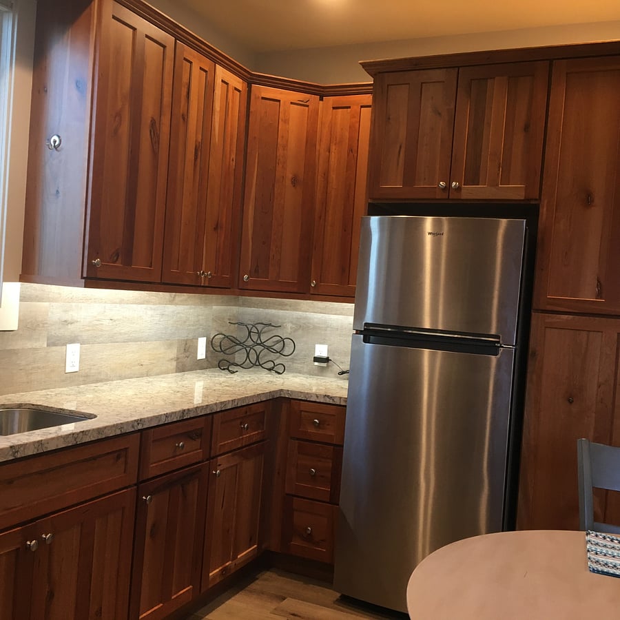 Kitchen looking in the other direction. Beautiful custom cherry cabinets and quartz countertops. 