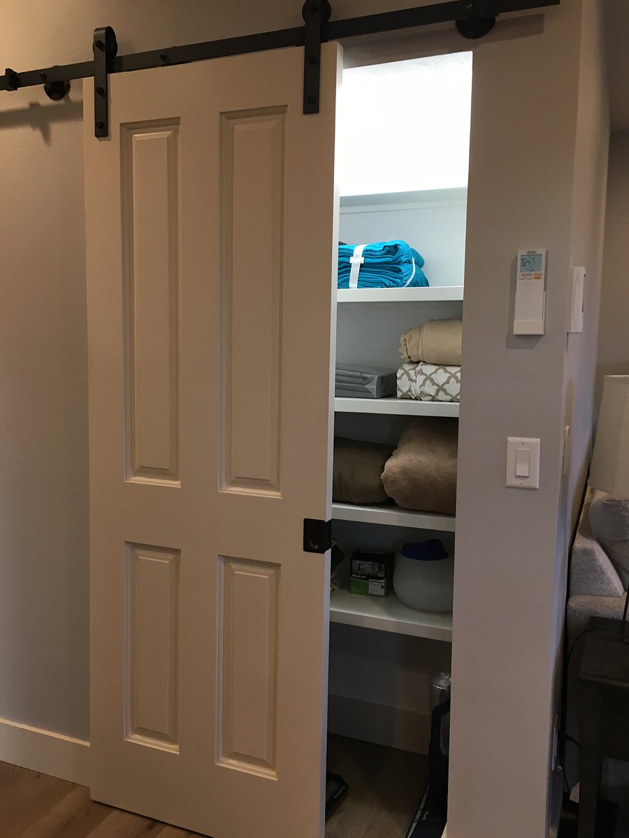 Linen closet in hallway. Well stocked with sheets, towels, extra comforters. 