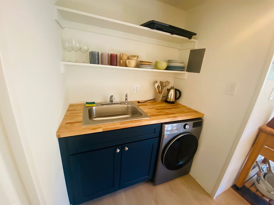 Sink, cabinet, and European washer/dryer combo. 
