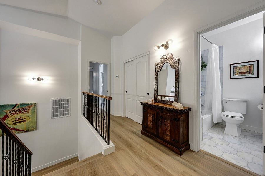 Upstairs layout with primary at one end and guest rooms at the other.