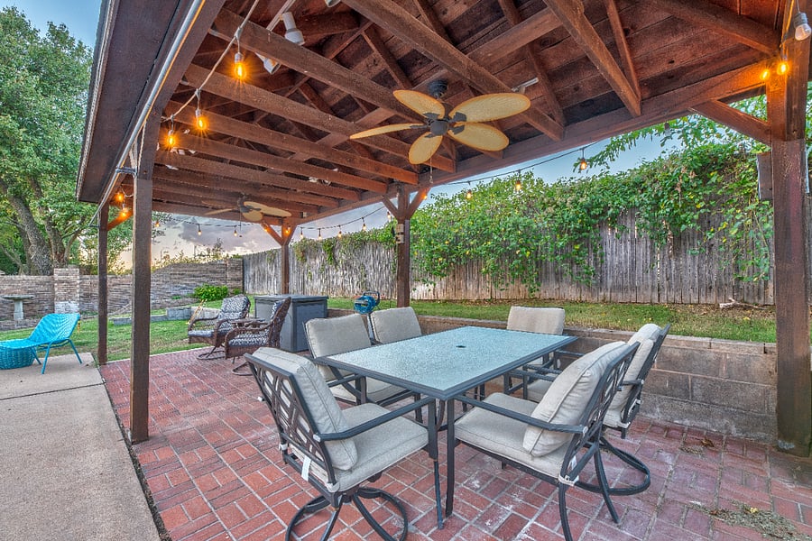 Covered back patio with dining set  ideal for morning coffee or unwinding outdoors.