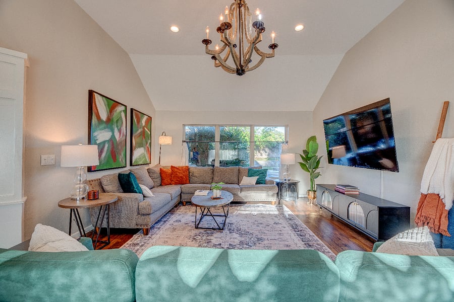 Spacious, cozy living room with smart 75" smart TV, fast WiFi, and plenty of natural light  perfect for relaxing after long shifts.