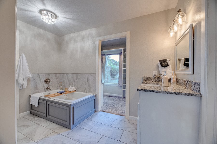 Large ensuite bathroom with jetted tub and seperate water closet  perfect for relaxing after long shifts.