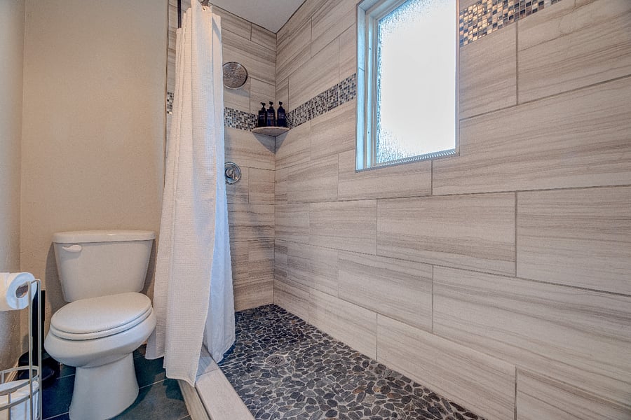 Clean, updated bathroom with full shower and essentials provided.