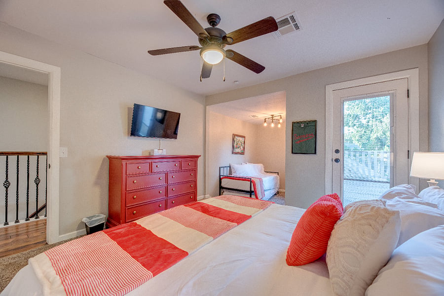 Upstairs bedroom with king bed and twin over twin trundle. It also features a 40" smart TV, and large private deck. 