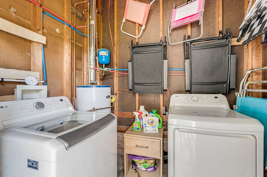 Laundry room with new washer and dryer off the carport. 