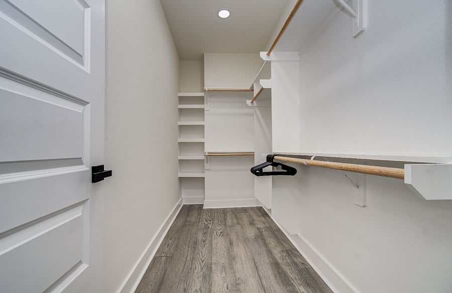 Primary walk in closet with plenty of storage