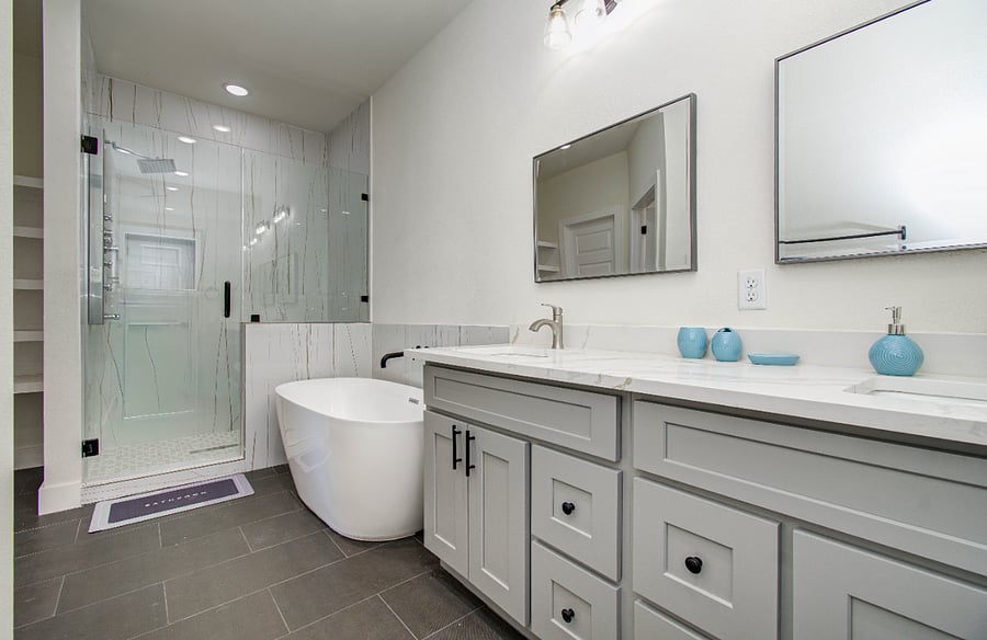 Ensuite primary bath with standing shower with shower tower including rain shower, stand alone tub