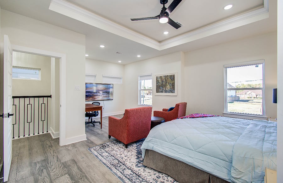 Spacious primary bedroom with king bed, plush mattress 