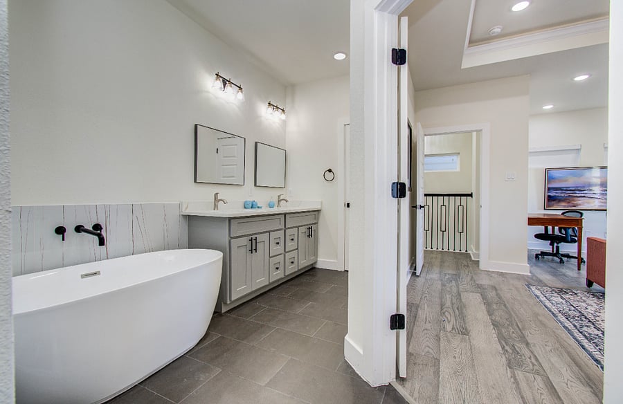 Ensuite primary bath with standing shower with shower tower including rain shower, stand alone tub