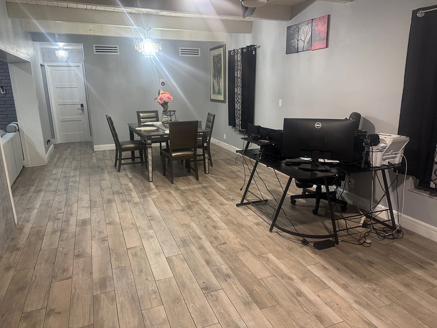 There is a nice dining table with a dedicated workspace next to it, including a computer and printer available for your work needs.