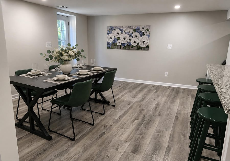 Dedicated dining area with a 6-seat table beside the kitchen island, finished with durable wood-look flooring.