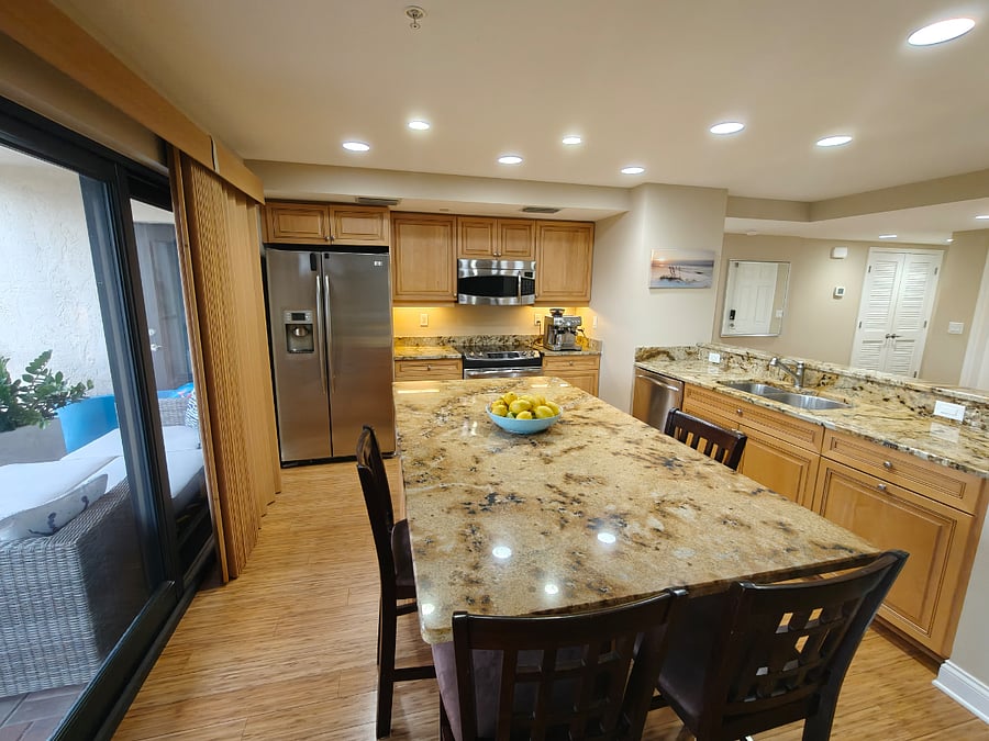 Kitchen w/ access to large Lanai & walk to pool/beach