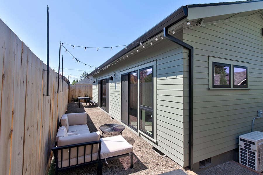 Private and fully fenced back patio with outdoor table and seating.