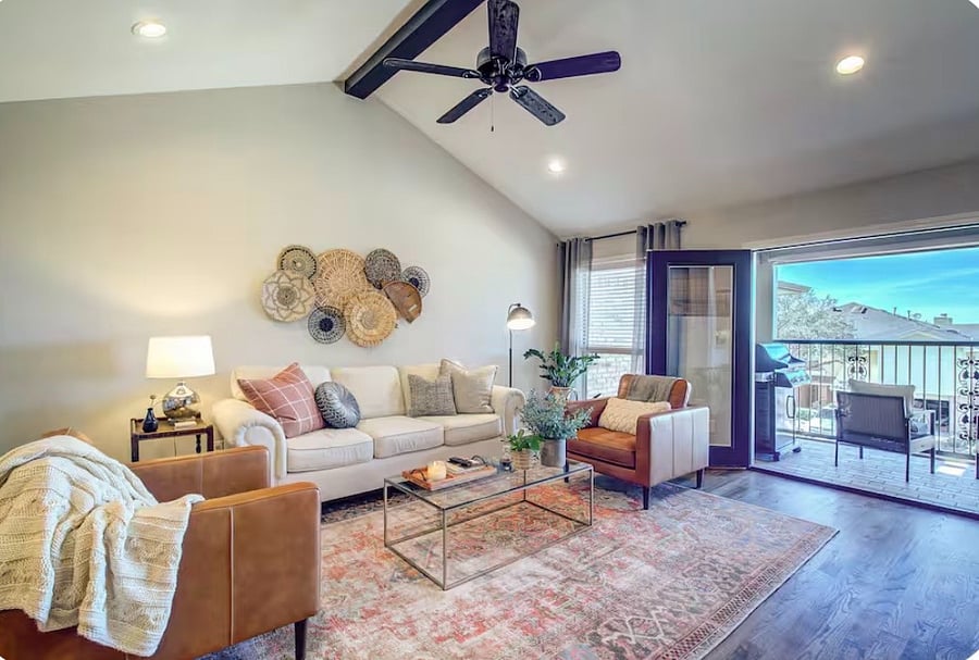 Living room with double doors opening up to the patio with lake views.