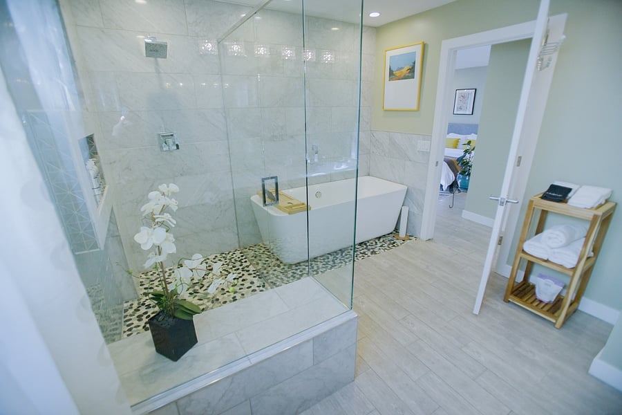 Luxurious bathroom featuring walk-in shower and freestanding tub