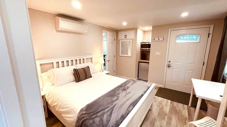 The ensuite Master Bedroom boasts a King bed, private entry to the front porch, a full bathroom with bathtub/shower, smart TV, wardrobe, work station, high speed WiFi, Kitchenette with mini-fridge, microwave, and coffee station.