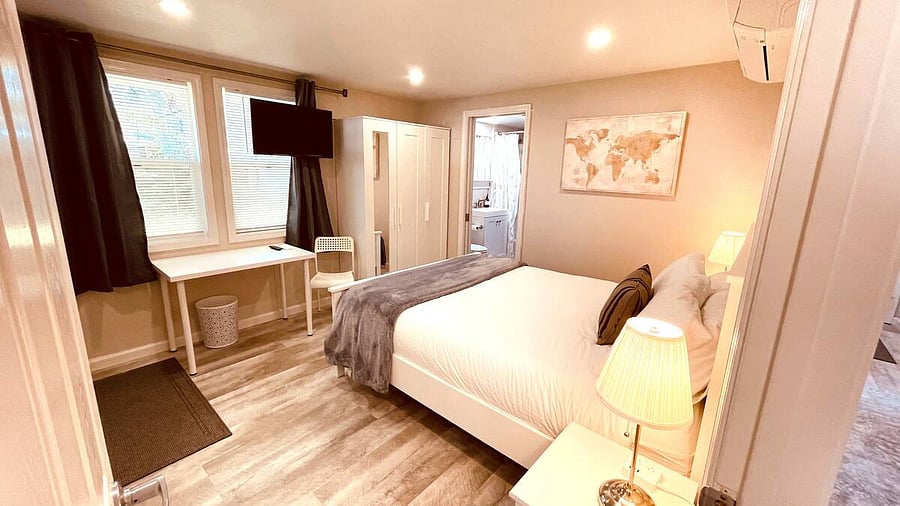 The ensuite Master Bedroom boasts a King bed, private entry to the front porch, a full bathroom with bathtub/shower, smart TV, wardrobe, work station, high speed WiFi, Kitchenette with mini-fridge, microwave, and coffee station.