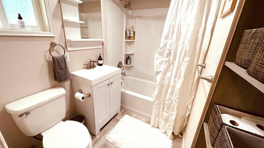 The private Master Bathroom boasts endless hot water, opening to the Master Bedroom with a King bed, private entry to the front porch, smart TV, wardrobe, work station, high speed WiFi, Kitchenette with mini-fridge, microwave, and coffee station.