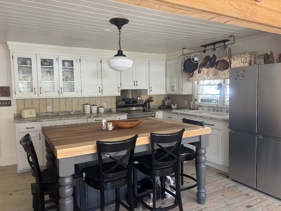 The heart of the house is the open kitchen and family room, and beautiful wooden island with seating for four.