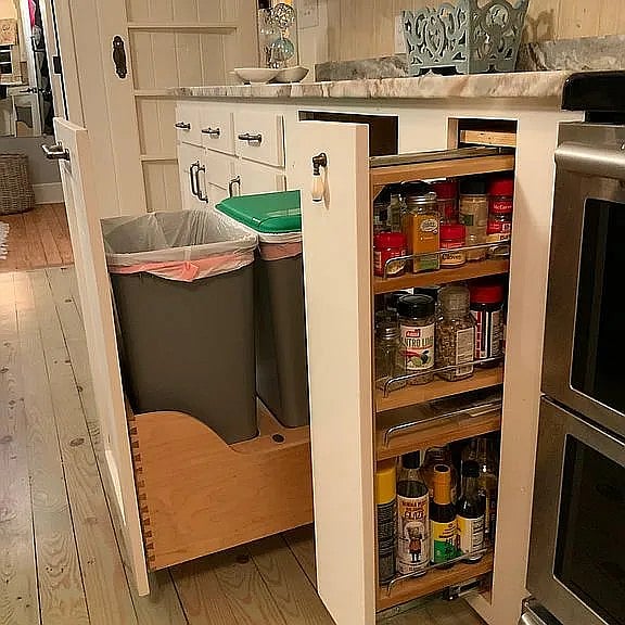 Trash is neatly tucked away in the kitchen cabinet, and next to it, plenty of kitchen supplies at your disposal.