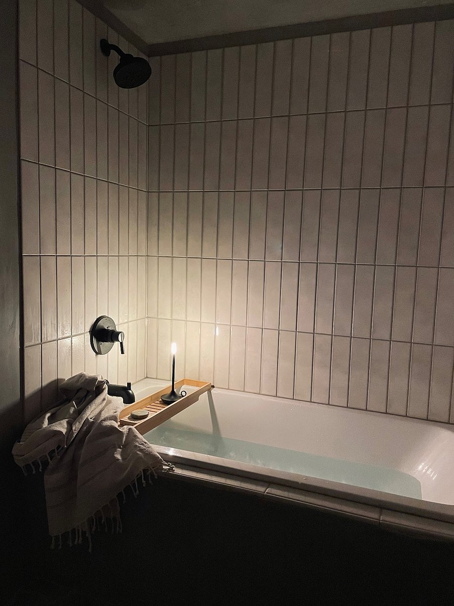 bathroom with full bathtub + shower.