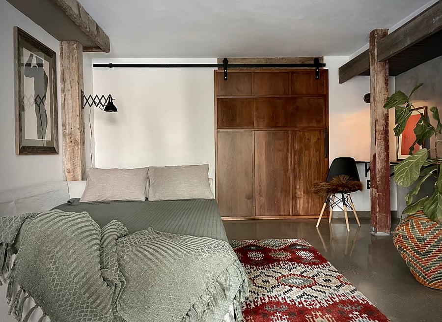 couch folds out to full bed and separate bedroom space, both rooms with access to bathroom and kitchen with sliding door closed.