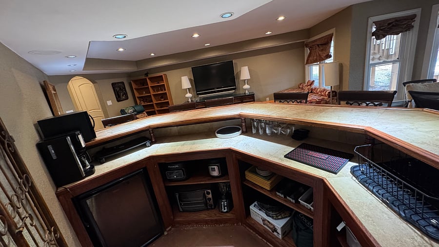 Wet bar featuring many small appliances including Microwave, Toaster Over, Crock Pot, Air Fryer, electric skillet, electric griddle and Wine Cooler!bedroom with full-sized bed, 