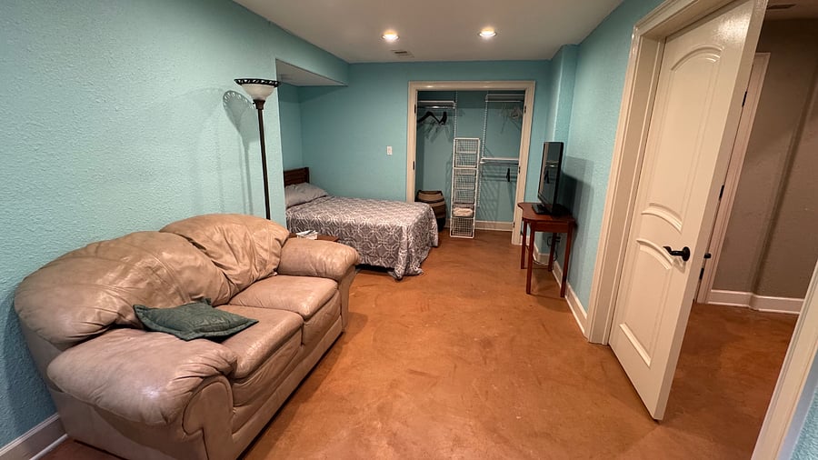 Private Bedroom with full-sized bed, large closet, Smart TV and sitting area with loveseat. 