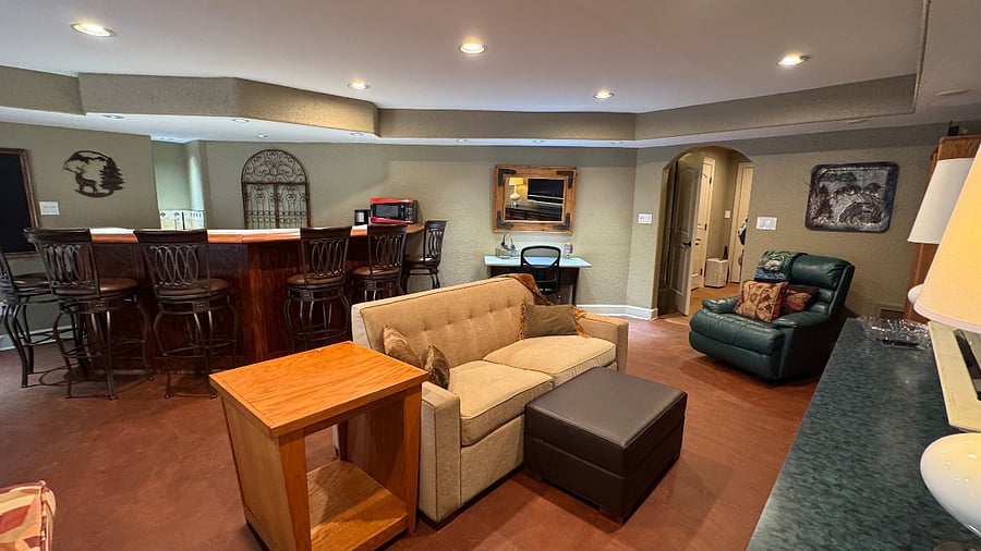 Your private living room featuring a love-seat sleeper, adjustable office desk for work or projects and large TV great for gaming!