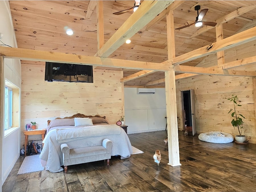Master Bedroom 28x32, king size bed, gas stove, couch, access to deck. Pine flooring and walls.