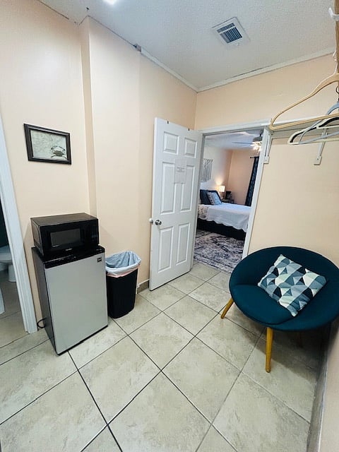 Laundry room with mini fridge and microwave. Entrance to bedroom off of laundry room. Bedroom can be locked separately from laundry room if needed.
