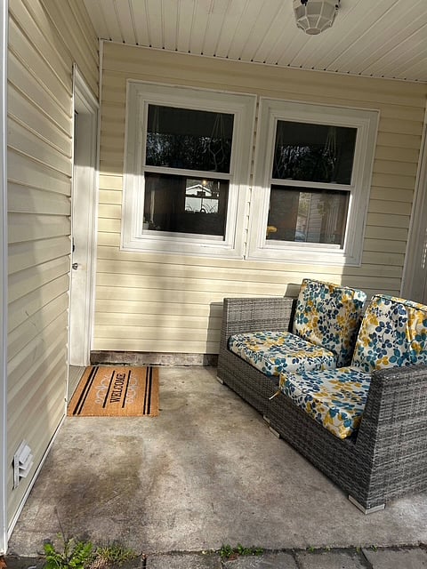 Entrance to guest suite with patio furniture.