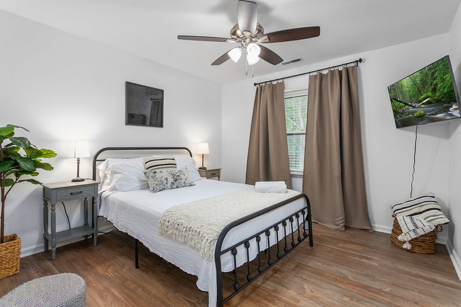 Upstairs on the second floor the first bedroom to the left. Bedroom 2: featuring a queen size bed, smart TV, full body mirror, closet space, and connecting door to the shared full bath.