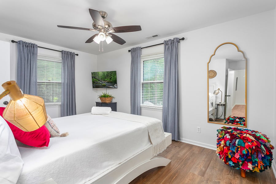 Bedroom 3: featuring a queen size bed, smart TV, full body mirror, walk-in closet, and connecting door to the shared full bath.