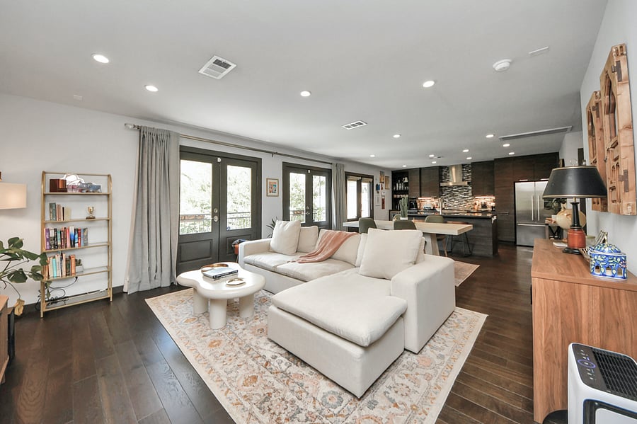 Relax on the sectional while enjoying the large smart TV and unique carved wooden artwork.